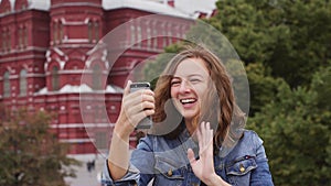 Tourist chating on facetime on the phone in front of Kremlin. Russia