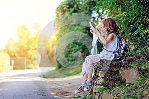 Tourist child girl with map traveling on summer vacations in Piran