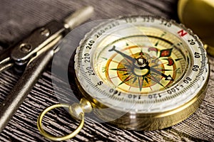 Tourist compas and circinus on wooden table