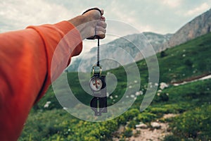 Tourist with compass in mountains