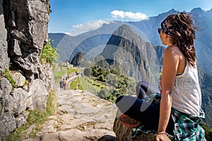 Tourist contemplating the beautiful landscape of Machu Picchu.