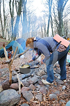 Tourist cooking on the campfire.