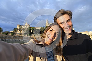 Tourist couple on holidays photographing a selfie photo