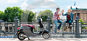 Tourist couple making stop during Vespa excursion in Berlin