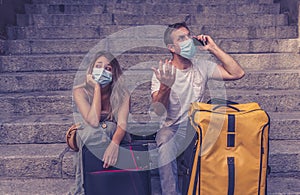 Tourist couple with protective face mask worried about covid test results before travel abroad