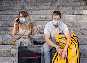 Tourist couple with protective face mask worried about covid test results before travel abroad