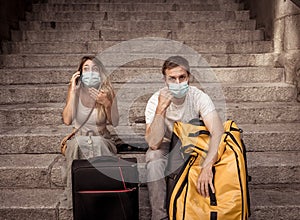 Tourist couple with protective face mask worried about covid test results before travel abroad