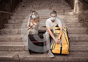 Tourist couple with protective face mask worried about covid test results before travel abroad