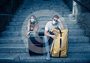 Tourist couple with protective face mask worried about new travel restrictions and quarantine