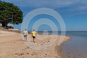Tourist couple in sand tourism beach Atlantic ocean in Ile de Noirmoutier France