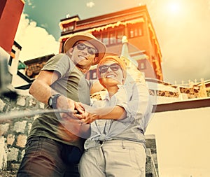 Tourist couple take a self photo on tibetian sight background