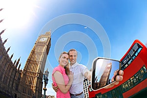 Tourist couple taking selfie against Big Ben in London, England, UK