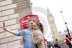 Tourist Couple taking selfie at Big Ben, London
