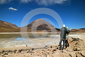 Tourist Couple Very Excited to See the Color of Water in the Lake Changing, Laguna Verde or Green Lake, Potosi, Bolivia photo