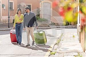 Tourist couple walking down the street looking for their hotel