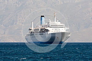 Tourist cruise sea liner is sailing in rocky bay