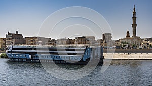 A tourist cruise ship is moored at the city pier.