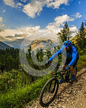 Tourist cycling in Cortina d`Ampezzo, stunning rocky mountains o