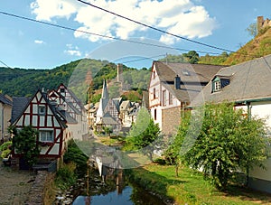 Tourist destination Monreal in rhineland-palatinate with half-timbered houses and ruin of castle Philippsburg