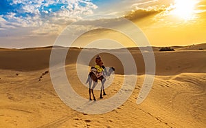 Tourist enjoy desert safari camel ride at Thar desert Jaisalmer, Rajasthan, India.