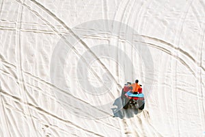 Tourist enjoy riding the quad bike or powerful fast off-road four-wheel drive ATVs at white sand dunes