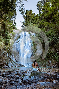 A tourist is enjoying the beauty of the waterfall in Chumphon province, Thailand , Klongphrao waterfall Thailand, girl