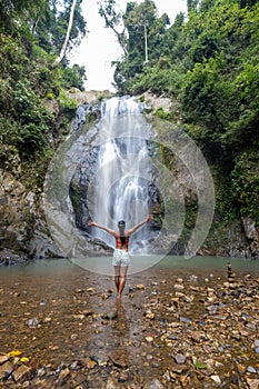 A tourist is enjoying the beauty of the waterfall in Chumphon province, Thailand , Klongphrao waterfall Thailand, girl