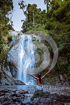 A tourist is enjoying the beauty of the waterfall in Chumphon province, Thailand , Klongphrao waterfall Thailand, girl