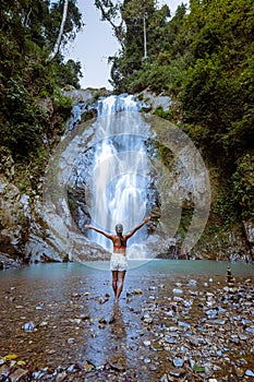 A tourist is enjoying the beauty of the waterfall in Chumphon province, Thailand , Klongphrao waterfall Thailand, girl