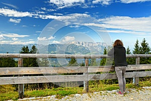 Tourist enjoying breathtaking lansdcape of Bavarian Alps with majestic mountains in the background.