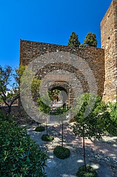 Tourist enjoying the gardens of the Alcazaba arab castle in Malaga