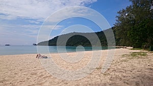 Tourist enjoying the sun on the sunset beach in Koh Rong Samloem