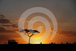 Tourist enjoying the sunset of Masai Mara