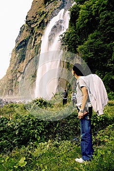 Tourist enjoying waterfall