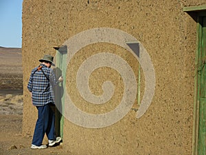 Tourist entering abandoned farmhouse in the Tankwa Karoo