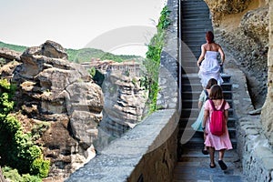 Tourist family visiting Meteora monastery in Greece