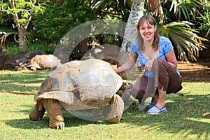 Tourist feeding giant turtle