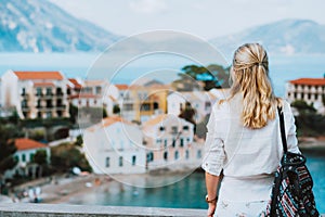 Tourist female enjoying greek small vivid colored Assos village. Kefalonia, Greece. Sommer vacation holiday vibes