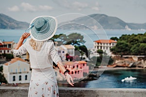 Tourist female enjoying greek small vivid colored Assos village. Kefalonia, Greece. Sommer vacation holiday vintage vibe