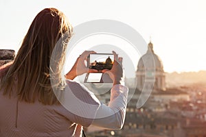 Tourist female taking picture smartphone. Travel to Rome, italy