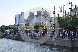 A tourist Ferris wheel with a boat and river view in Montreal\'s Old Harbour, Canada, in summer photo