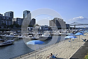 A tourist Ferris wheel with a boat and river view in Montreal\'s Old Harbour, Canada, in summer photo