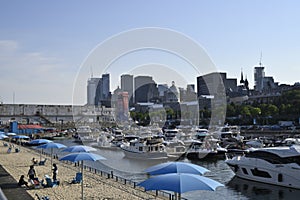 A tourist Ferris wheel with a boat and river view in Montreal\'s Old Harbour, Canada, in summer photo