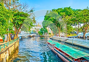 The tourist ferry sails along canal in Bangkok, Thailand