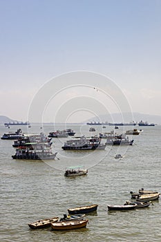 Tourist and fishing boats in the bay in front of the Gateway of India, Mumbai, Maharashtra, India