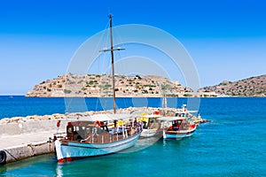 Tourist and fishing boats at the pier of the village of Plaka, n