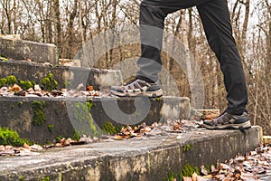 Tourist  in a forest going up the old stairs