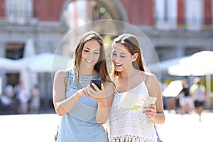 Tourist friends consulting an online guide