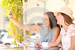 Tourist friends taking a selfie photo with smartphone