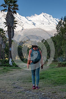 Tourist in front of the snowy Huascaran mountain.